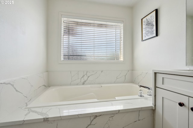 full bathroom with vanity and a garden tub