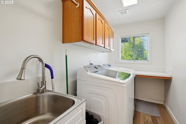 clothes washing area featuring cabinet space, independent washer and dryer, wood finished floors, baseboards, and an office area