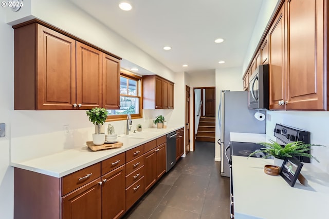 kitchen featuring stainless steel appliances, sink, and dark tile patterned floors