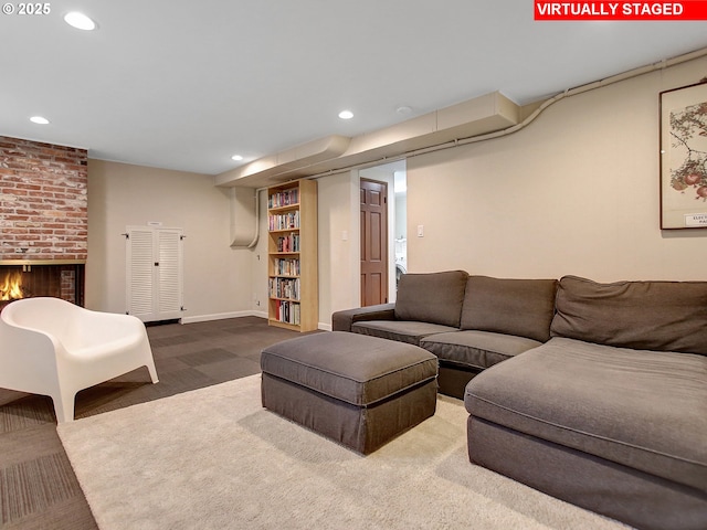 carpeted living room with a brick fireplace