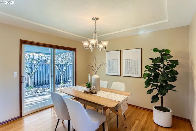 dining room featuring an inviting chandelier and light hardwood / wood-style flooring