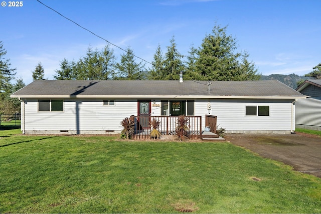 rear view of property with a lawn