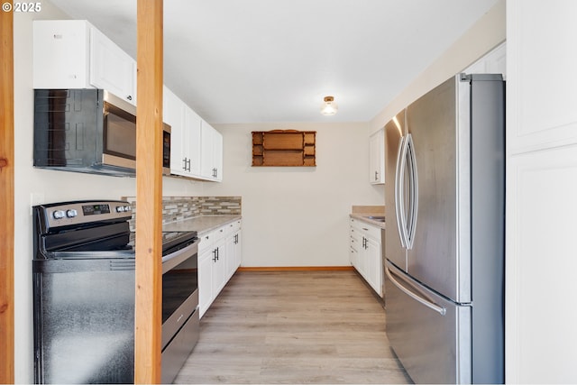 kitchen with light hardwood / wood-style flooring, stainless steel appliances, backsplash, and white cabinetry