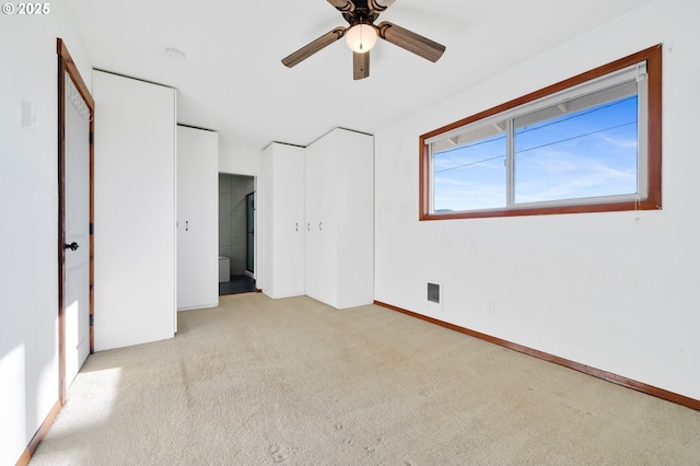 unfurnished bedroom with light carpet and ceiling fan