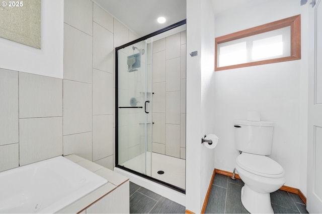 bathroom featuring tile patterned floors, toilet, and separate shower and tub