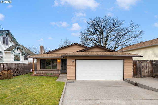 view of front of home with a front lawn, fence, a garage, and driveway