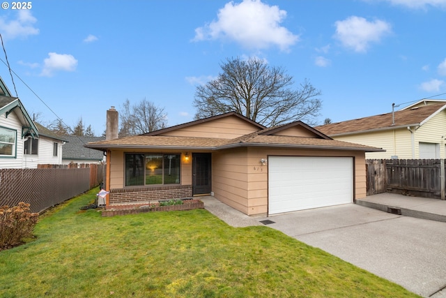 view of front of house with fence, concrete driveway, a front yard, a chimney, and a garage