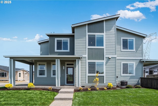 view of front of house with fence, central AC unit, a porch, and a front lawn