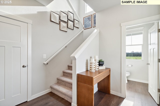 stairway featuring wood finished floors and baseboards