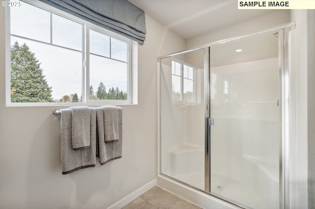 bathroom with tile patterned floors, a shower stall, recessed lighting, and baseboards