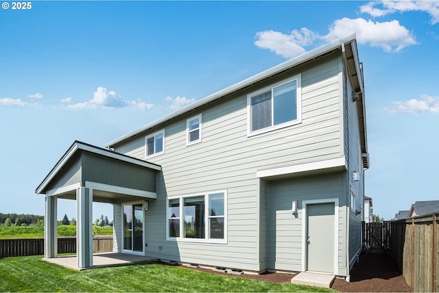 back of house with a lawn, a patio area, and a fenced backyard