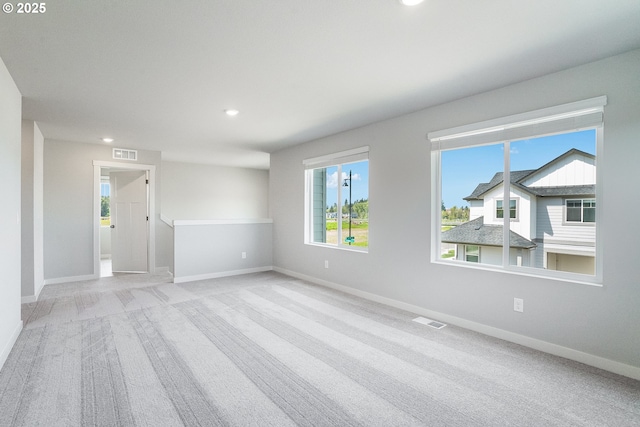 spare room with recessed lighting, visible vents, carpet, and baseboards