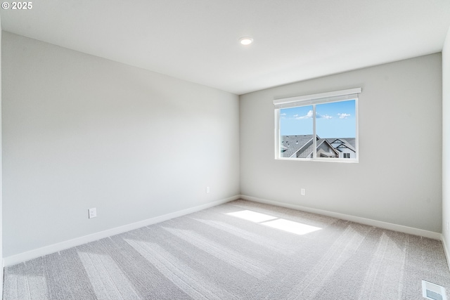 unfurnished room with visible vents, carpet flooring, and baseboards