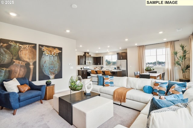 living area with baseboards and recessed lighting