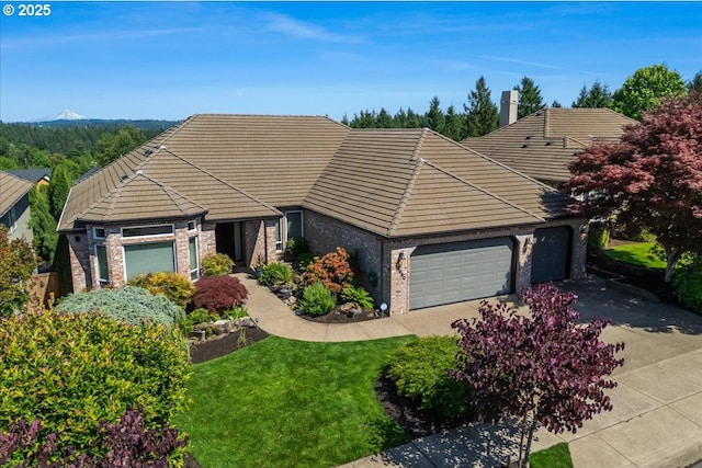 23680 SW Robson Ter, Sherwood, OR 97140 - view of front of property with a garage, brick siding, a tile roof, and asphalt driveway