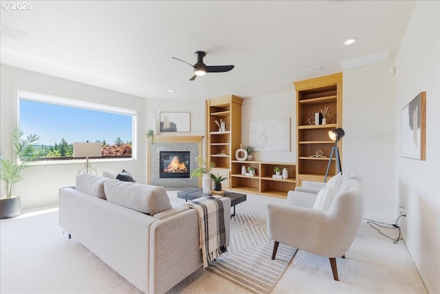 23680 SW Robson Ter, Sherwood, OR 97140 - living room with ceiling fan, a glass covered fireplace, light carpet, built in shelves, and recessed lighting