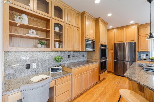 23680 SW Robson Ter, Sherwood, OR 97140 - kitchen featuring stainless steel appliances, dark stone countertops, glass insert cabinets, light wood finished floors, and recessed lighting