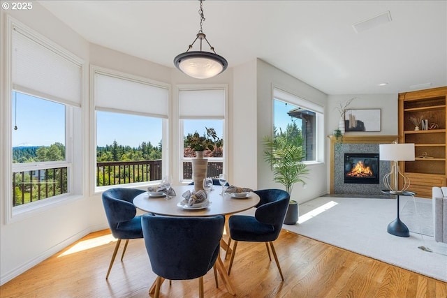 23680 SW Robson Ter, Sherwood, OR 97140 - dining room featuring wood finished floors and a glass covered fireplace