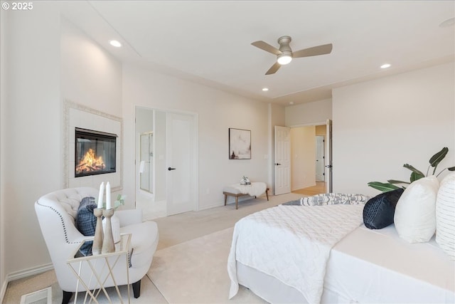 23680 SW Robson Ter, Sherwood, OR 97140 - bedroom with light carpet, recessed lighting, a glass covered fireplace, and ceiling fan