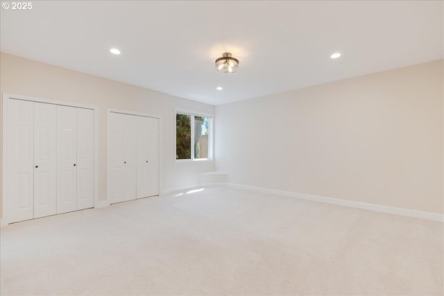 23680 SW Robson Ter, Sherwood, OR 97140 - unfurnished bedroom with light carpet, multiple closets, and recessed lighting