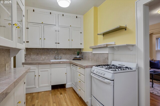 5851 NE 12th Ave, Portland, OR 97211 - kitchen with white appliances, light wood-type flooring, white cabinetry, light countertops, and a wainscoted wall
