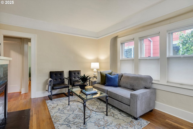 5851 NE 12th Ave, Portland, OR 97211 - living area featuring wood finished floors, baseboards, and a brick fireplace