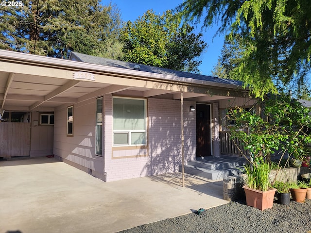 1582 N Ivy St, Coquille, OR 97423 - view of front of property with brick siding and an attached carport