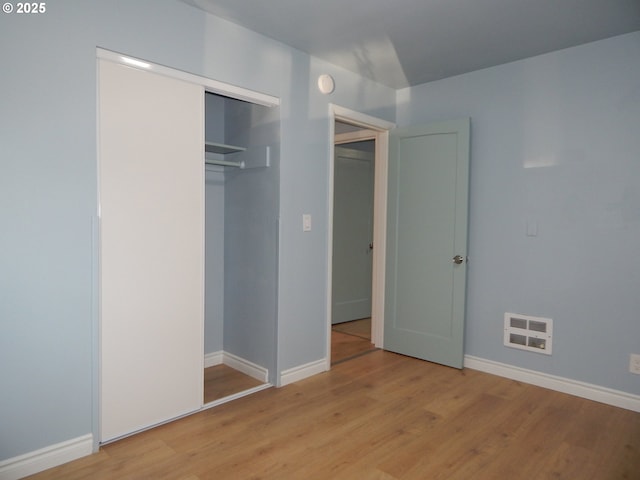 1582 N Ivy St, Coquille, OR 97423 - unfurnished bedroom featuring light wood finished floors, baseboards, and a closet