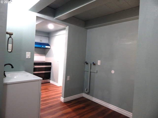 1582 N Ivy St, Coquille, OR 97423 - bathroom with a sink, wood finished floors, and baseboards
