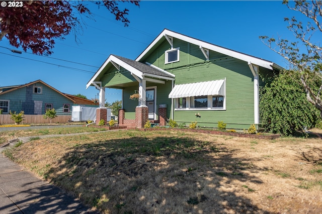 bungalow-style home featuring a porch and fence