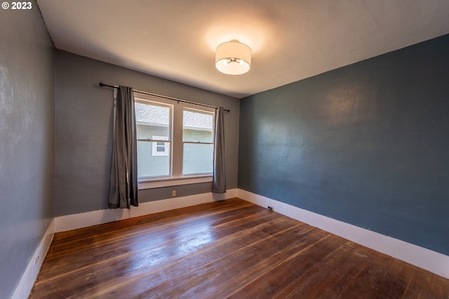 empty room with wood finished floors and baseboards