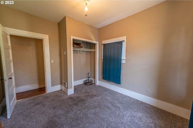 unfurnished bedroom with visible vents, baseboards, carpet flooring, and a closet