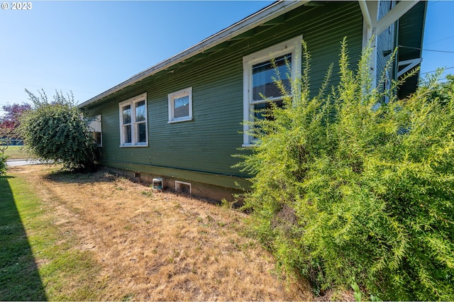 view of side of home featuring a lawn