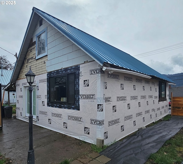 view of side of property with metal roof and a standing seam roof