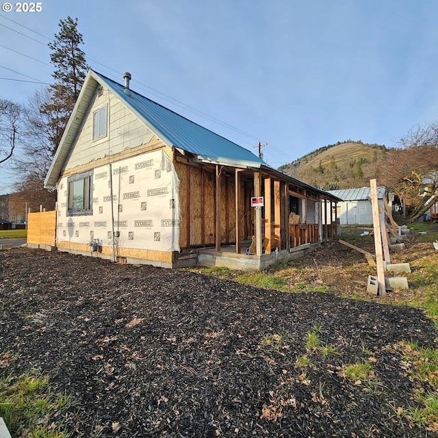 view of property exterior with metal roof