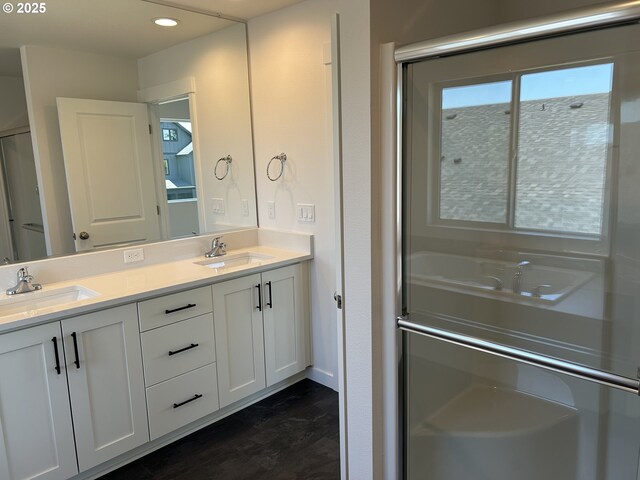 2940 Olympic St Unit 21, Woodburn, OR 97071 - bathroom with double vanity, wood finished floors, recessed lighting, and an enclosed shower