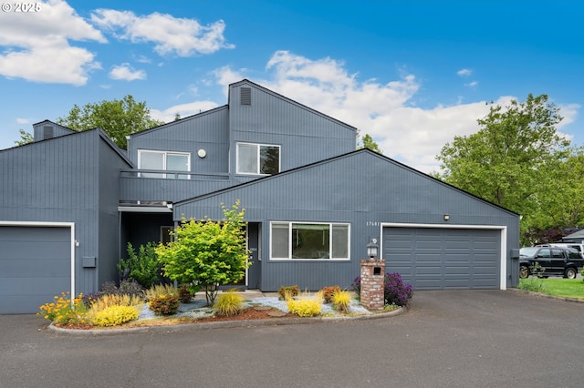 view of front facade with a garage and asphalt driveway