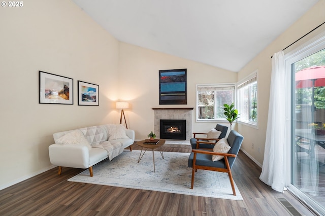 living room with dark wood-style floors, a fireplace, baseboards, and lofted ceiling