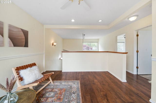 living area with wood finished floors, ceiling fan, baseboards, an upstairs landing, and recessed lighting