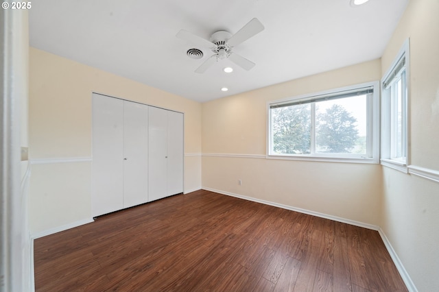 unfurnished bedroom with dark wood-style floors, baseboards, recessed lighting, a closet, and a ceiling fan