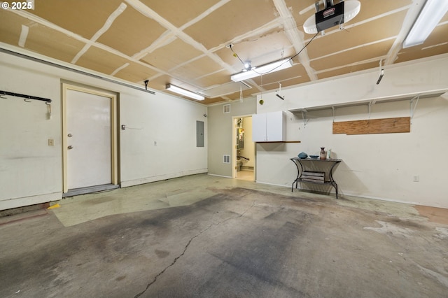 garage featuring a garage door opener and electric panel