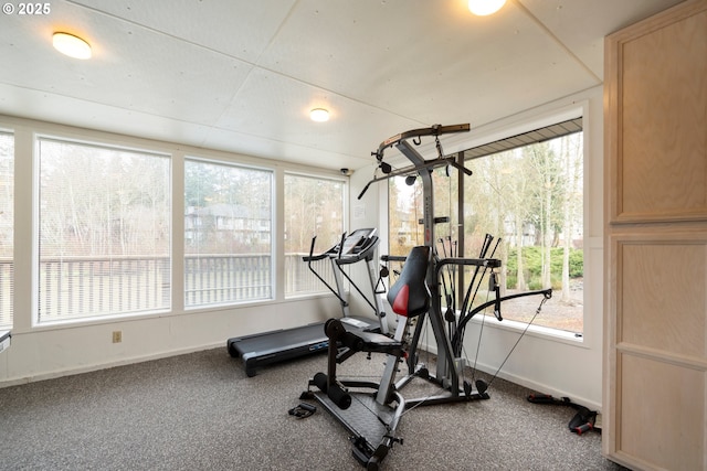exercise room with healthy amount of natural light and baseboards