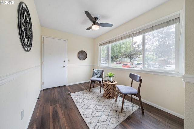 sitting room with wood finished floors, ceiling fan, and baseboards