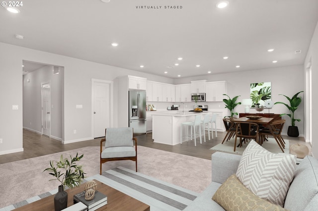 living room featuring sink and dark hardwood / wood-style floors