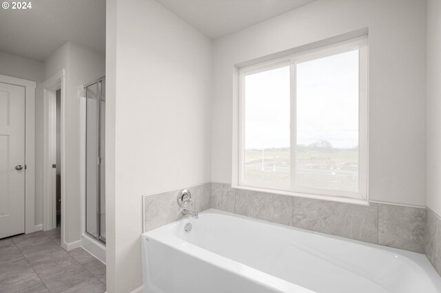 bathroom featuring shower with separate bathtub