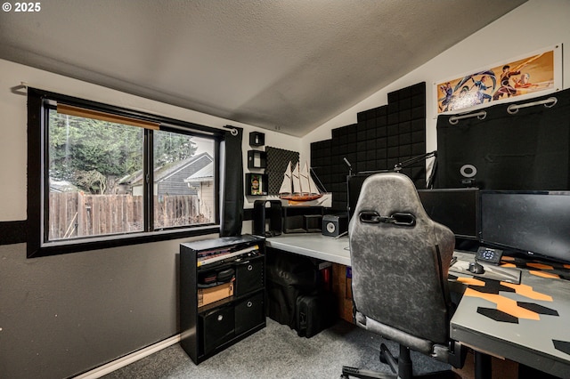 carpeted office with vaulted ceiling, a textured ceiling, and baseboards