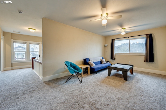 carpeted living area featuring baseboards