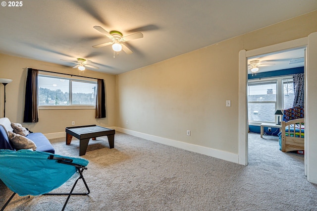 living room featuring carpet floors, a healthy amount of sunlight, and baseboards