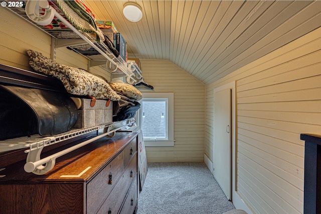 walk in closet featuring vaulted ceiling and light colored carpet