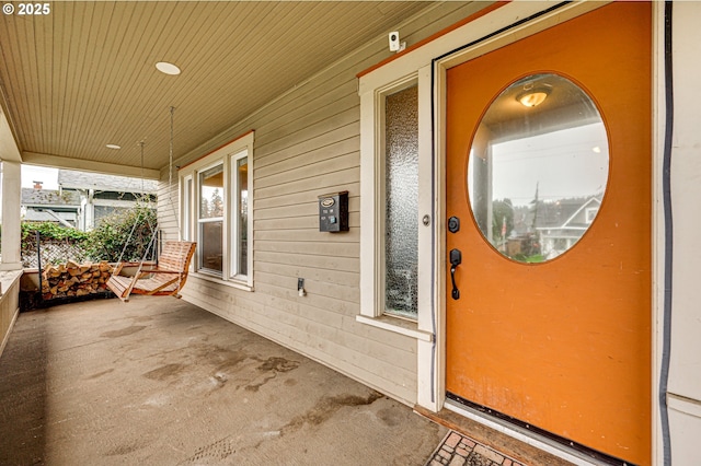 view of exterior entry with a porch